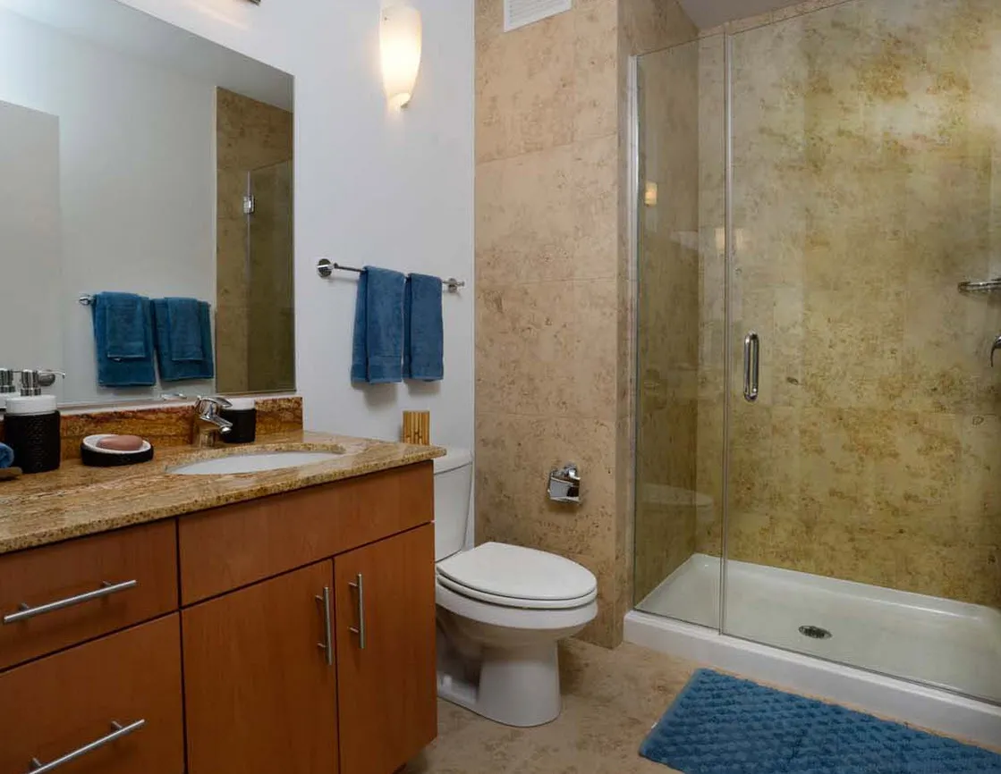living room with wood floors and downtown view at Aston Chicago Apartments