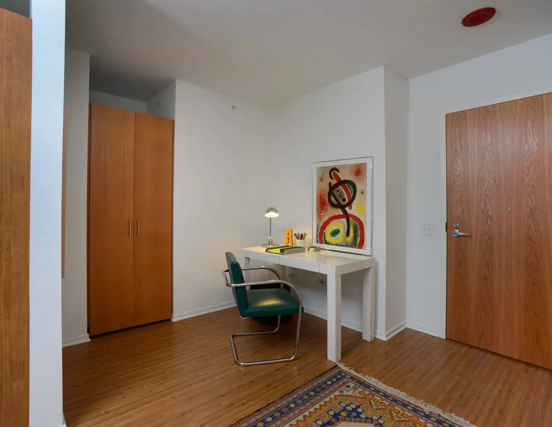 living room with wood floors and downtown view at Aston Chicago Apartments