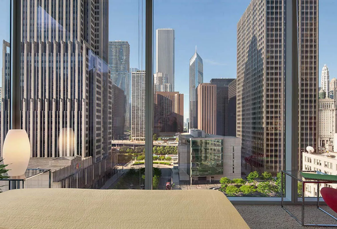 living room with wood floors and downtown view at Aston Chicago Apartments