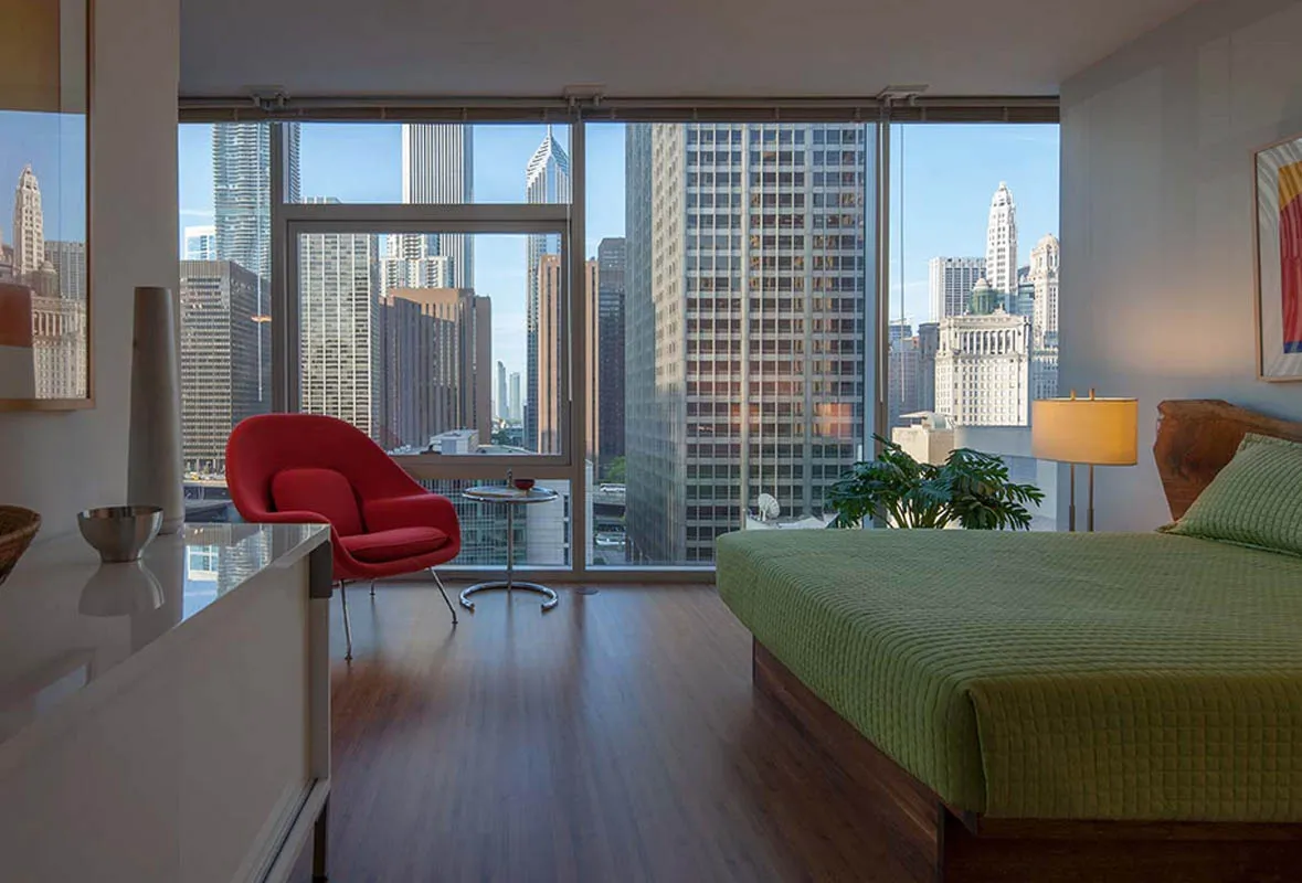 living room with wood floors and downtown view at Aston Chicago Apartments