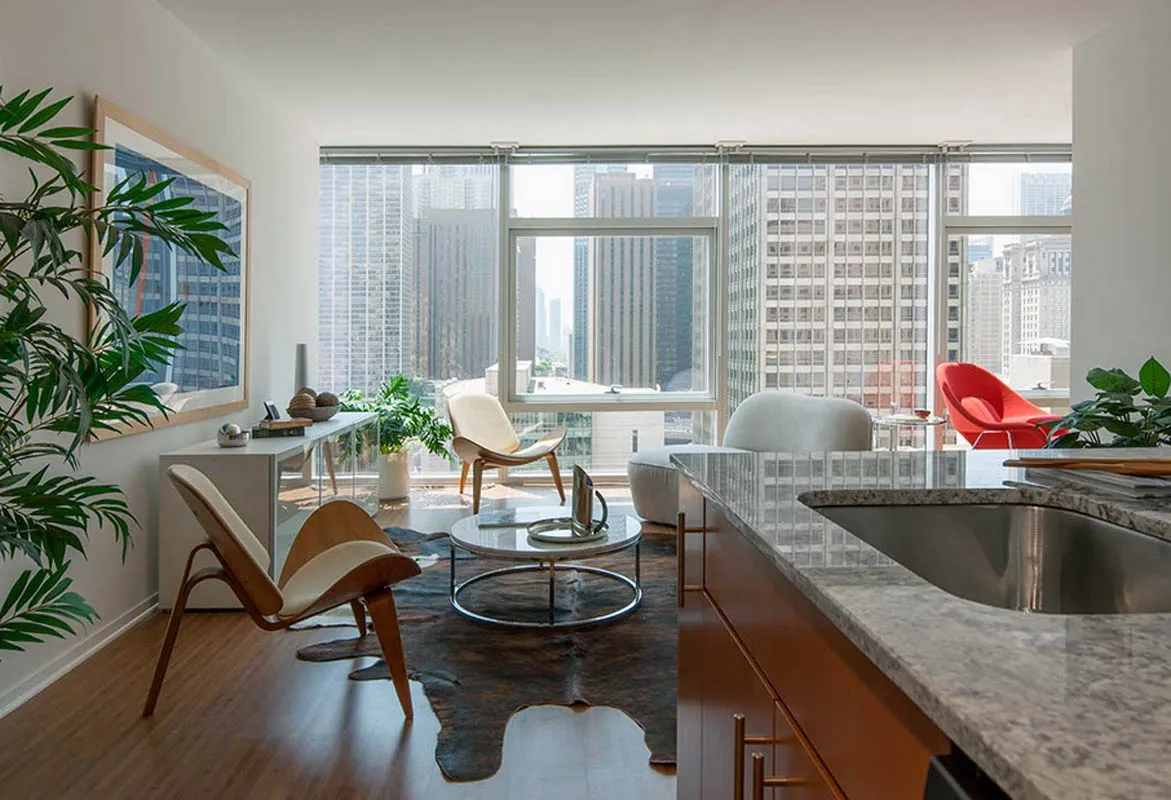 living room with wood floors and downtown view at Aston Chicago Apartments