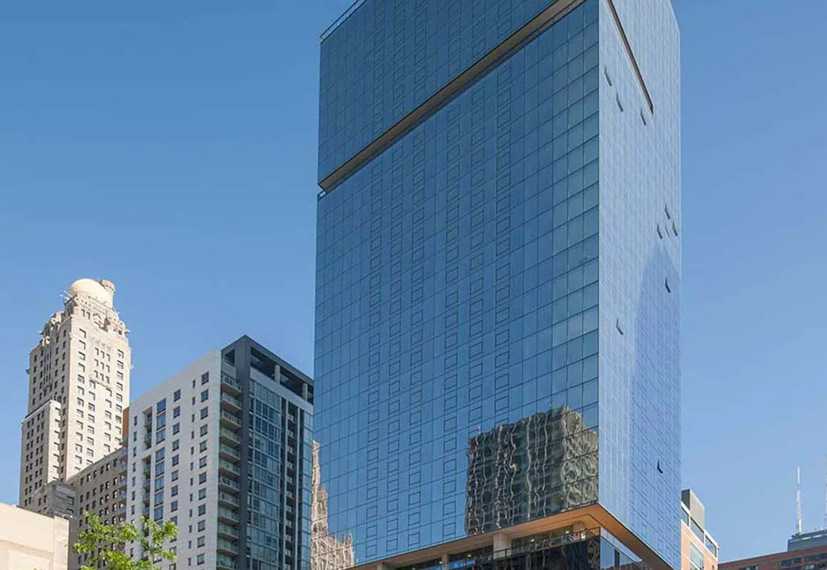 living room with wood floors and downtown view at Aston Chicago Apartments