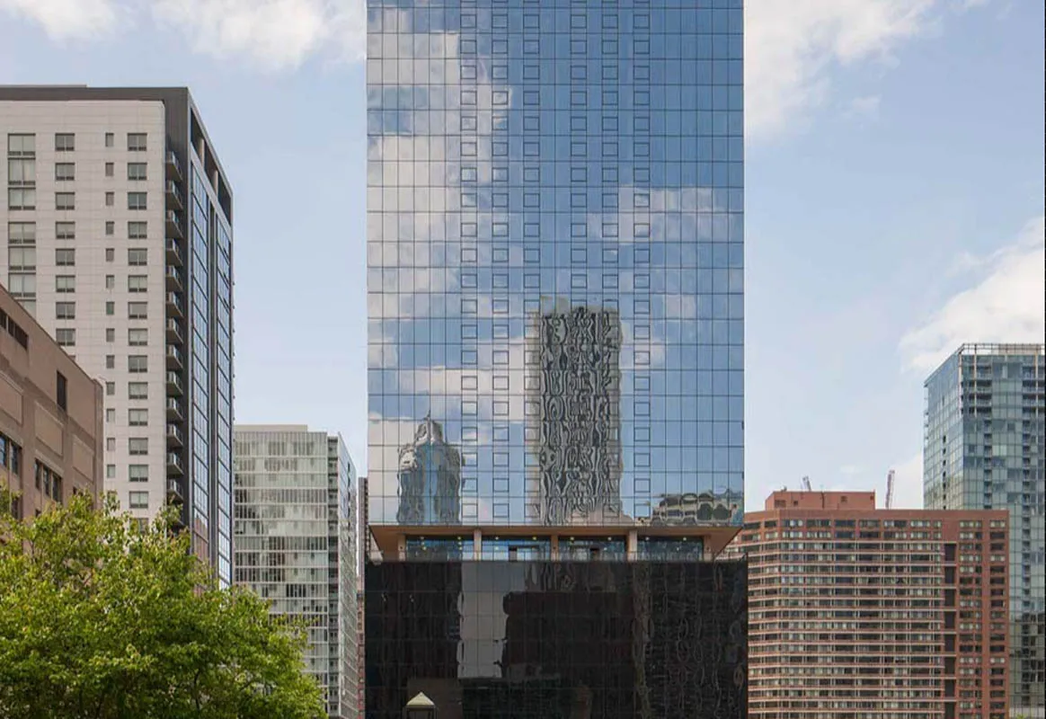 living room with wood floors and downtown view at Aston Chicago Apartments