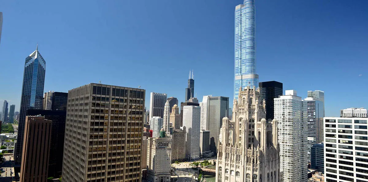living room with wood floors and downtown view at Aston Chicago Apartments