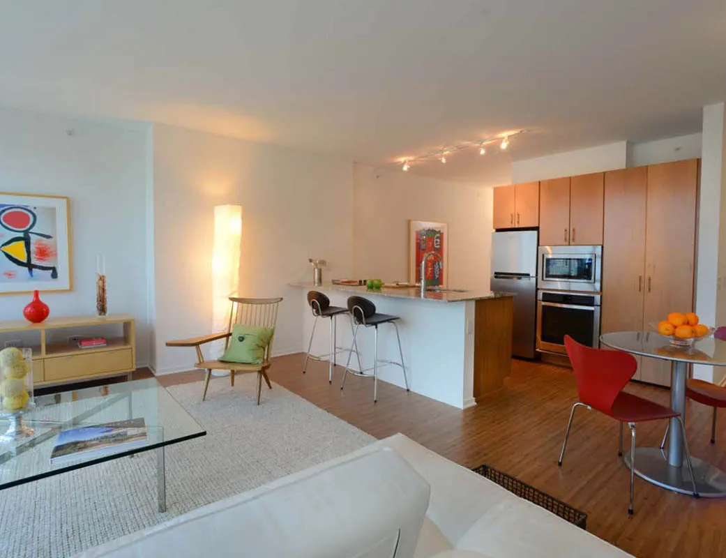 living room with wood floors and downtown view at Aston Chicago Apartments