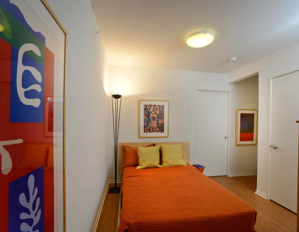 living room with wood floors and downtown view at Aston Chicago Apartments