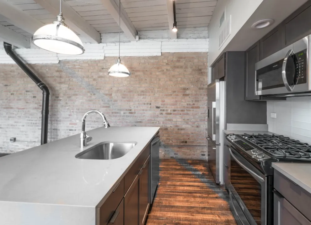 model kitchen with timber ceiling and brick wall- 1012 West Randolph Lofts