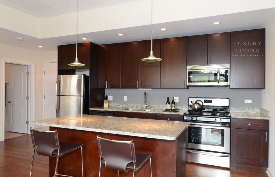 kitchen and island with wood floors at Riverview Terrace Apartments