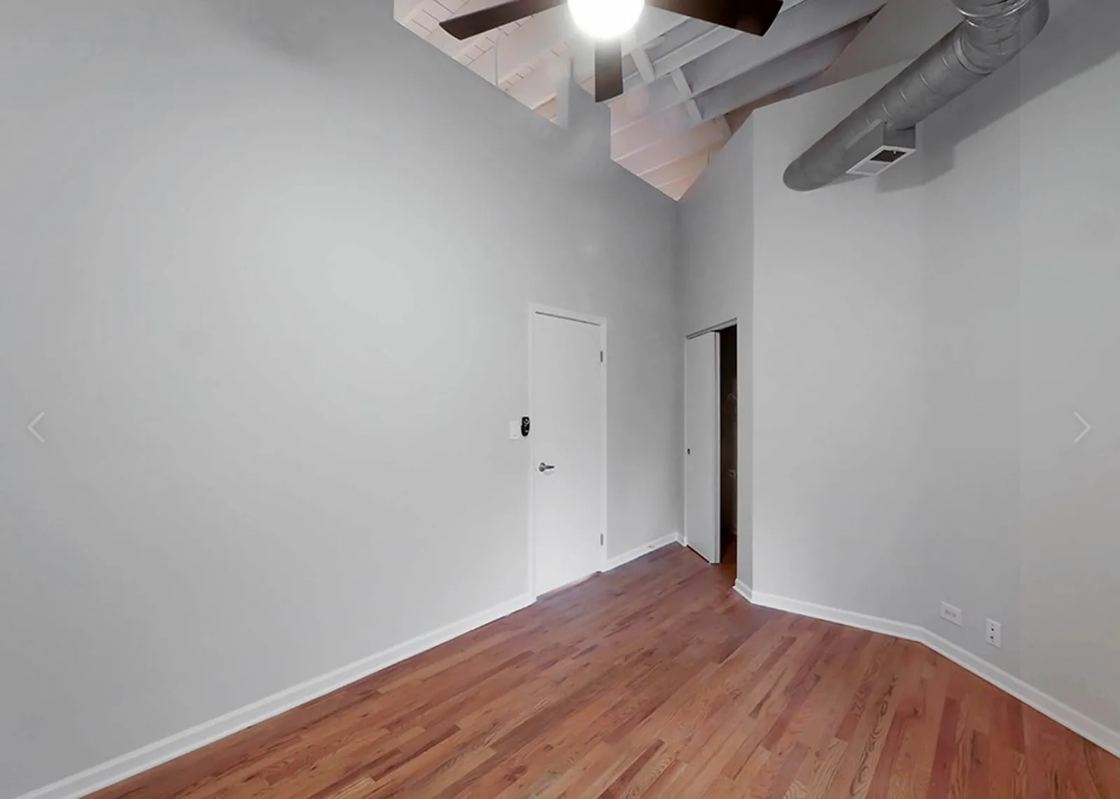 giant loft living room with wood floors at 1550 North Damen Lofts