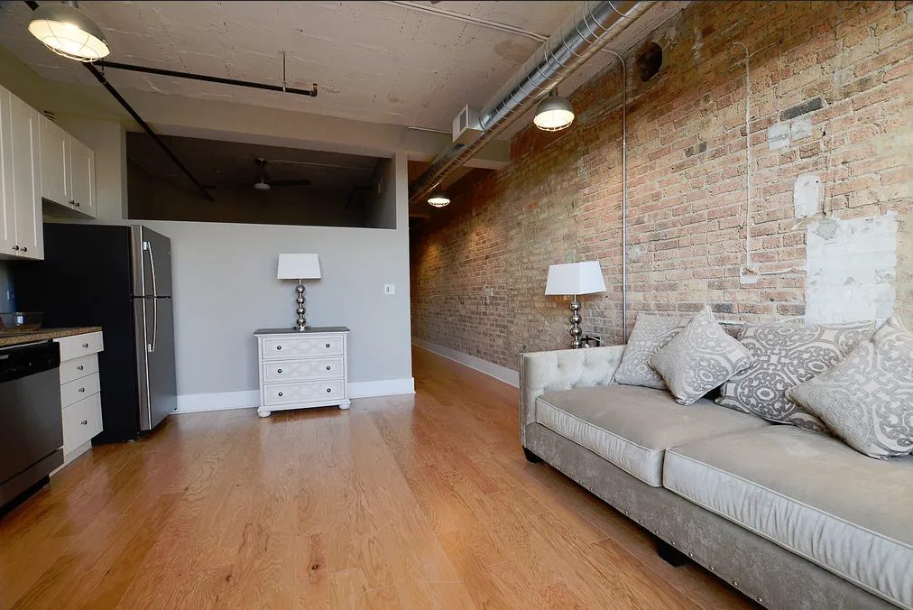 exposed brick in living room of 3141 North Sheffield Apartments in Lakeview