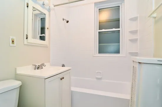 front view of whote frame windows and red brick- 815-833 Mulford Apartments