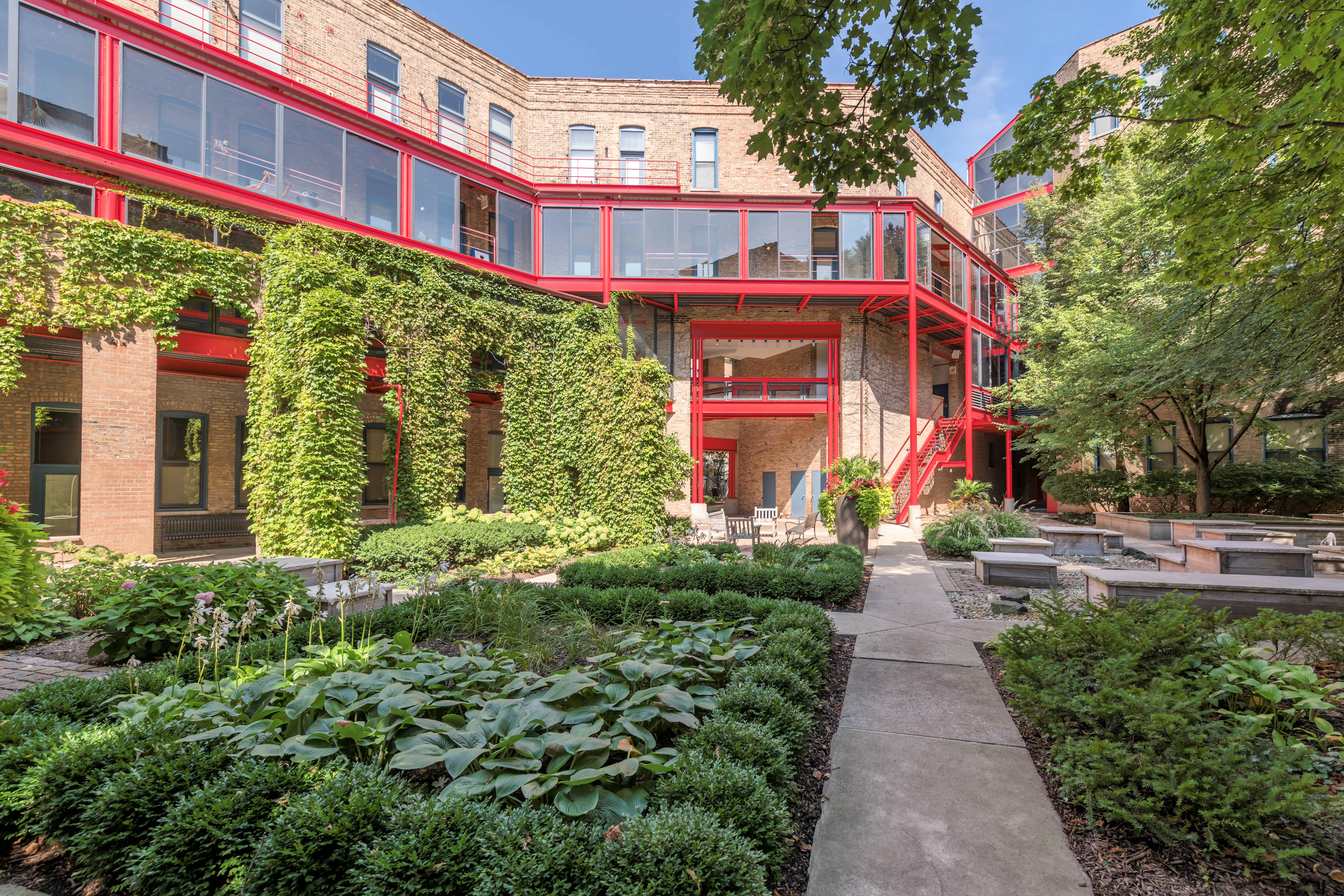 bedroom with exposed wood beam ceiling at Cobbler Square Lofts