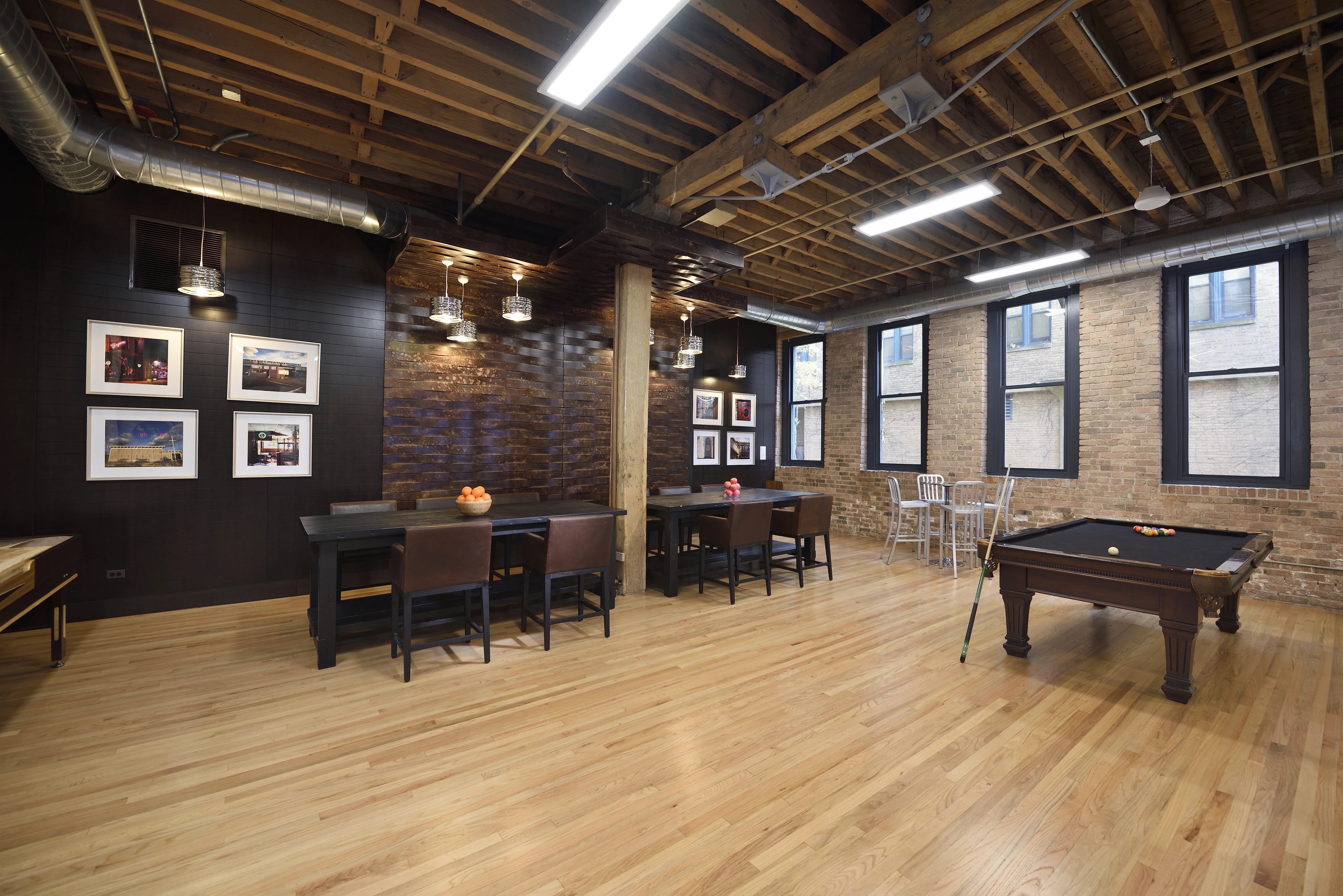 bedroom with exposed wood beam ceiling at Cobbler Square Lofts