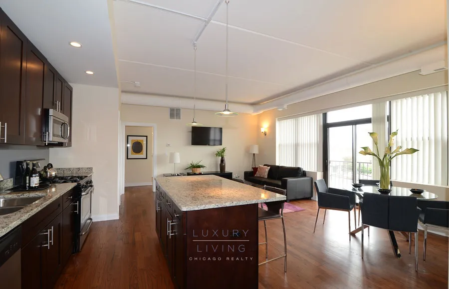 kitchen and island with wood floors at Riverview Terrace Apartments