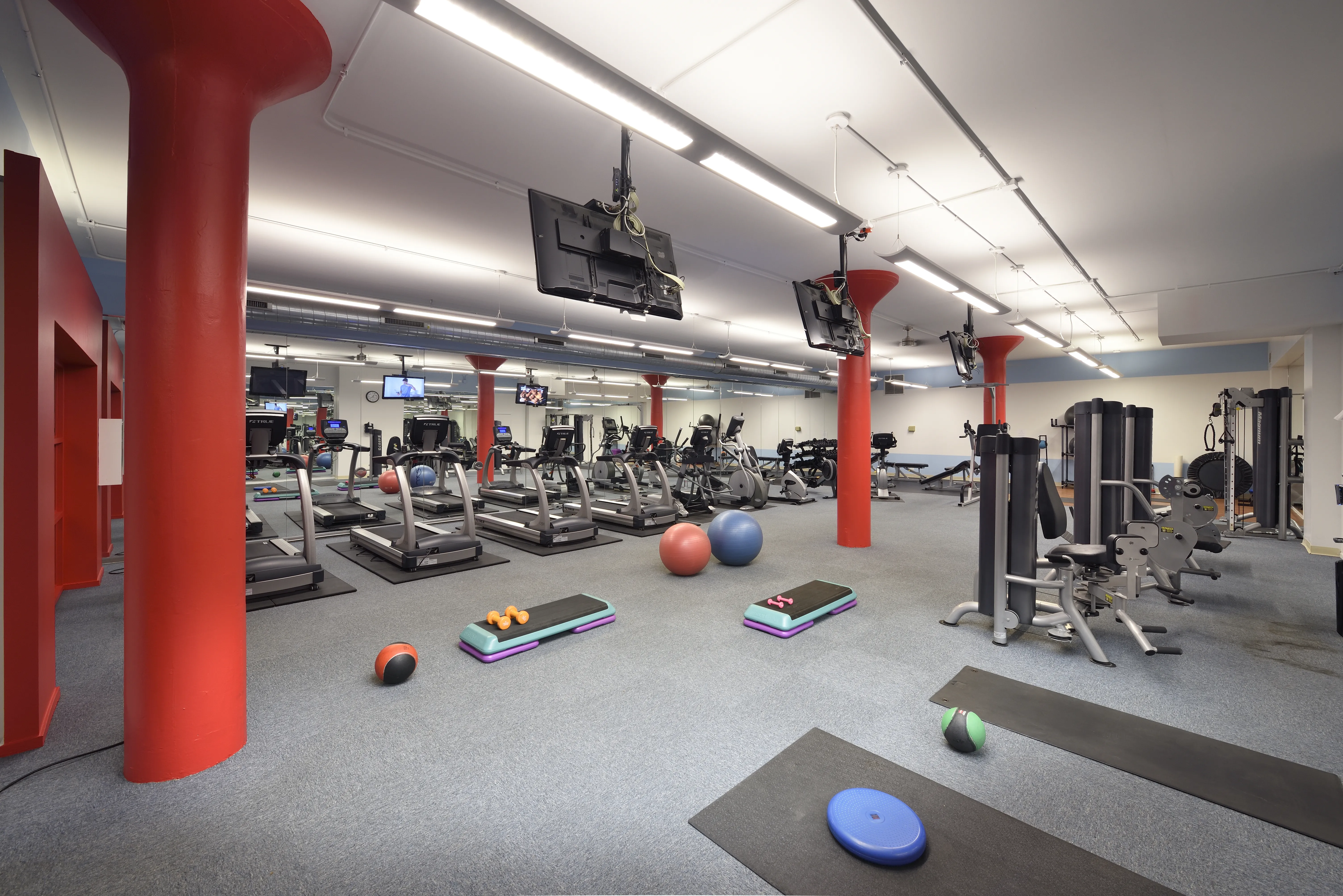 bedroom with exposed wood beam ceiling at Cobbler Square Lofts