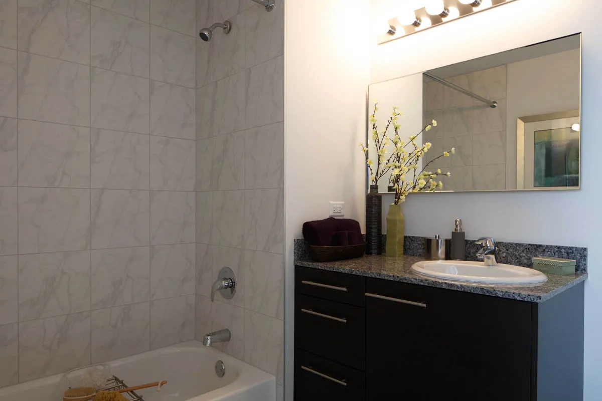 furnished living room with glass window at SoNo East Apartments