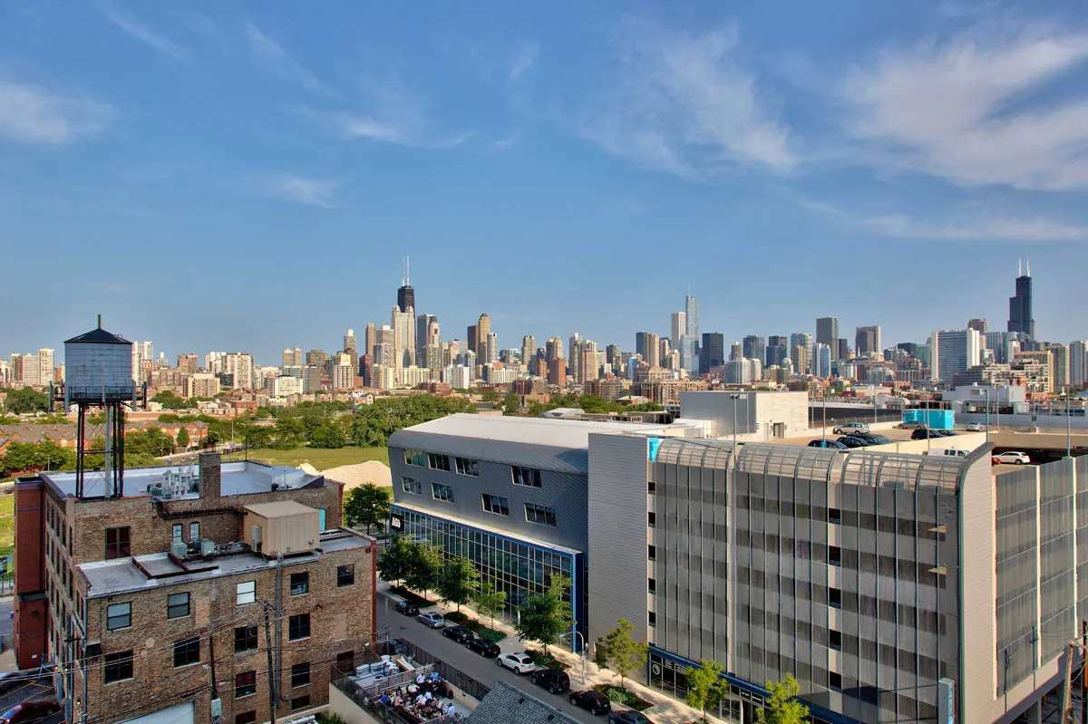 furnished living room with glass window at SoNo East Apartments