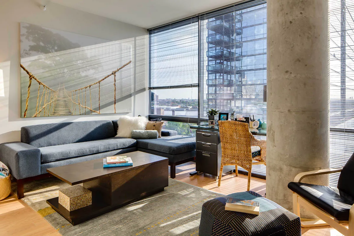 furnished living room with glass window at SoNo East Apartments