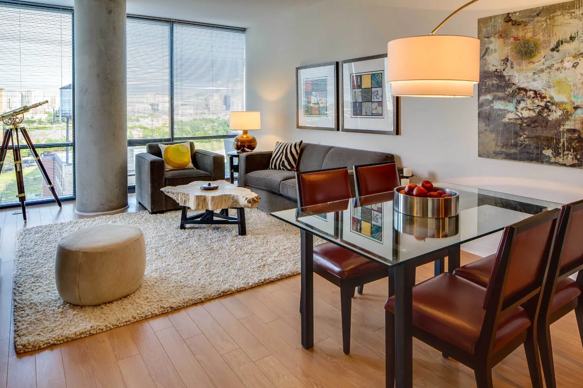 furnished living room with glass window at SoNo East Apartments