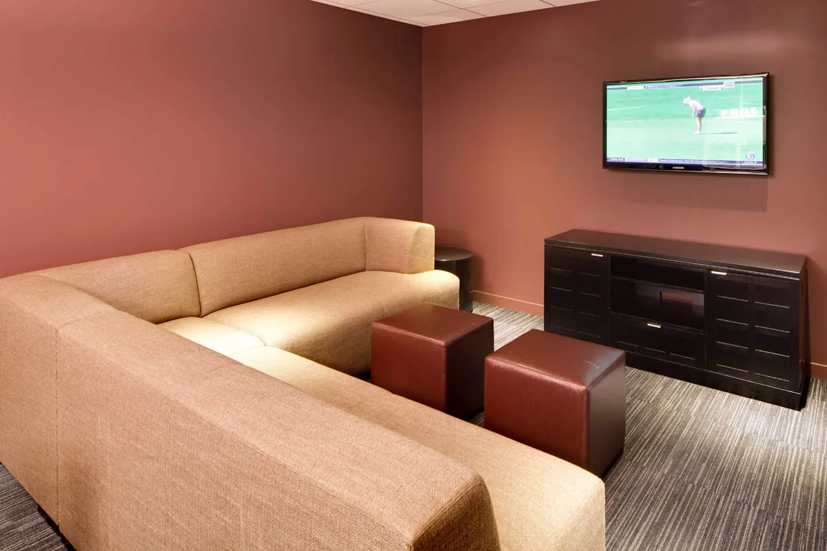 furnished living room with glass window at SoNo East Apartments