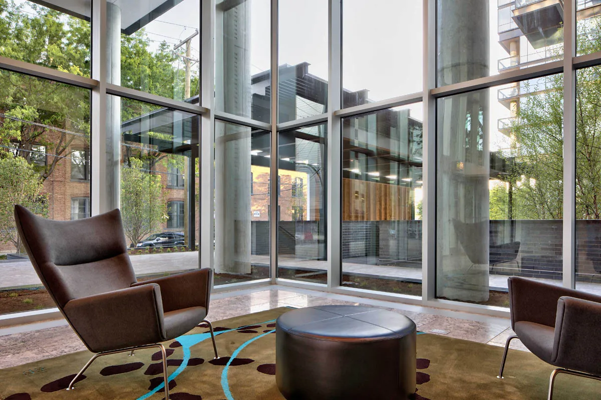 furnished living room with glass window at SoNo East Apartments