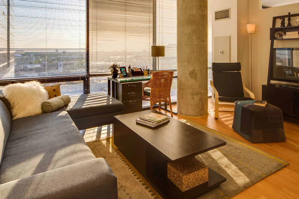 furnished living room with glass window at SoNo East Apartments
