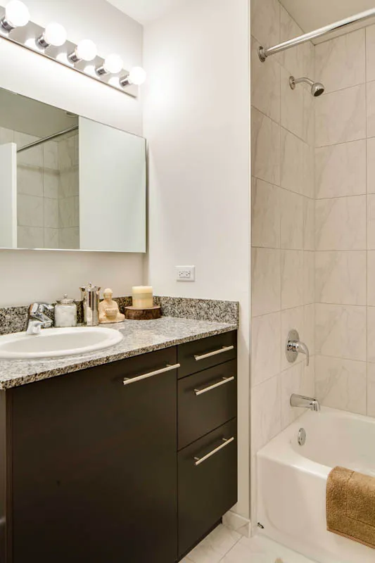 furnished living room with glass window at SoNo East Apartments