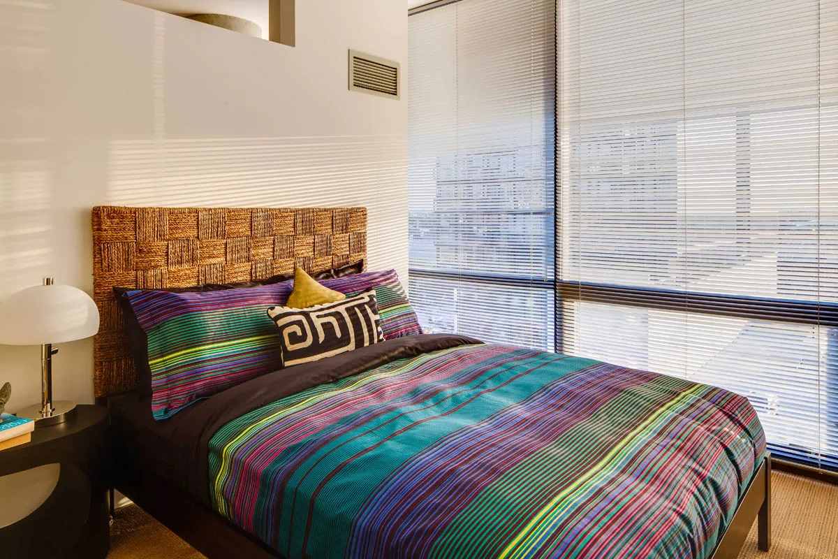 furnished living room with glass window at SoNo East Apartments