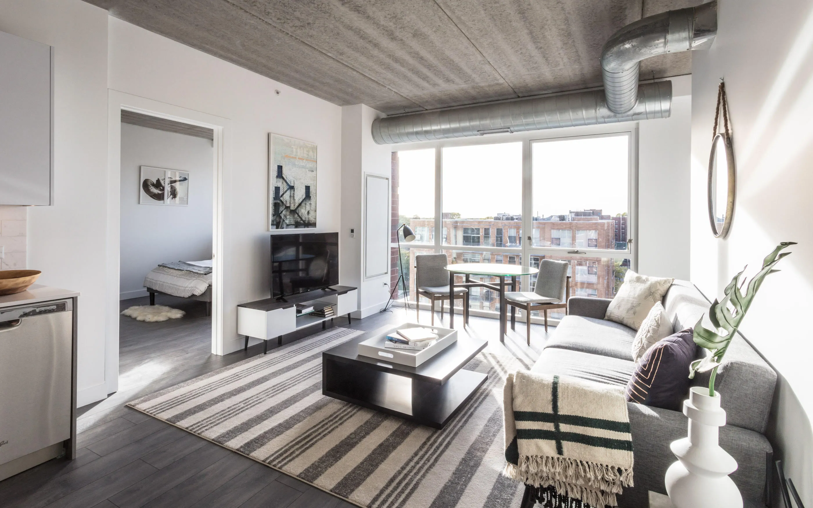 kitchen and living area in one bedroom model at Centrum Evanston Apartments