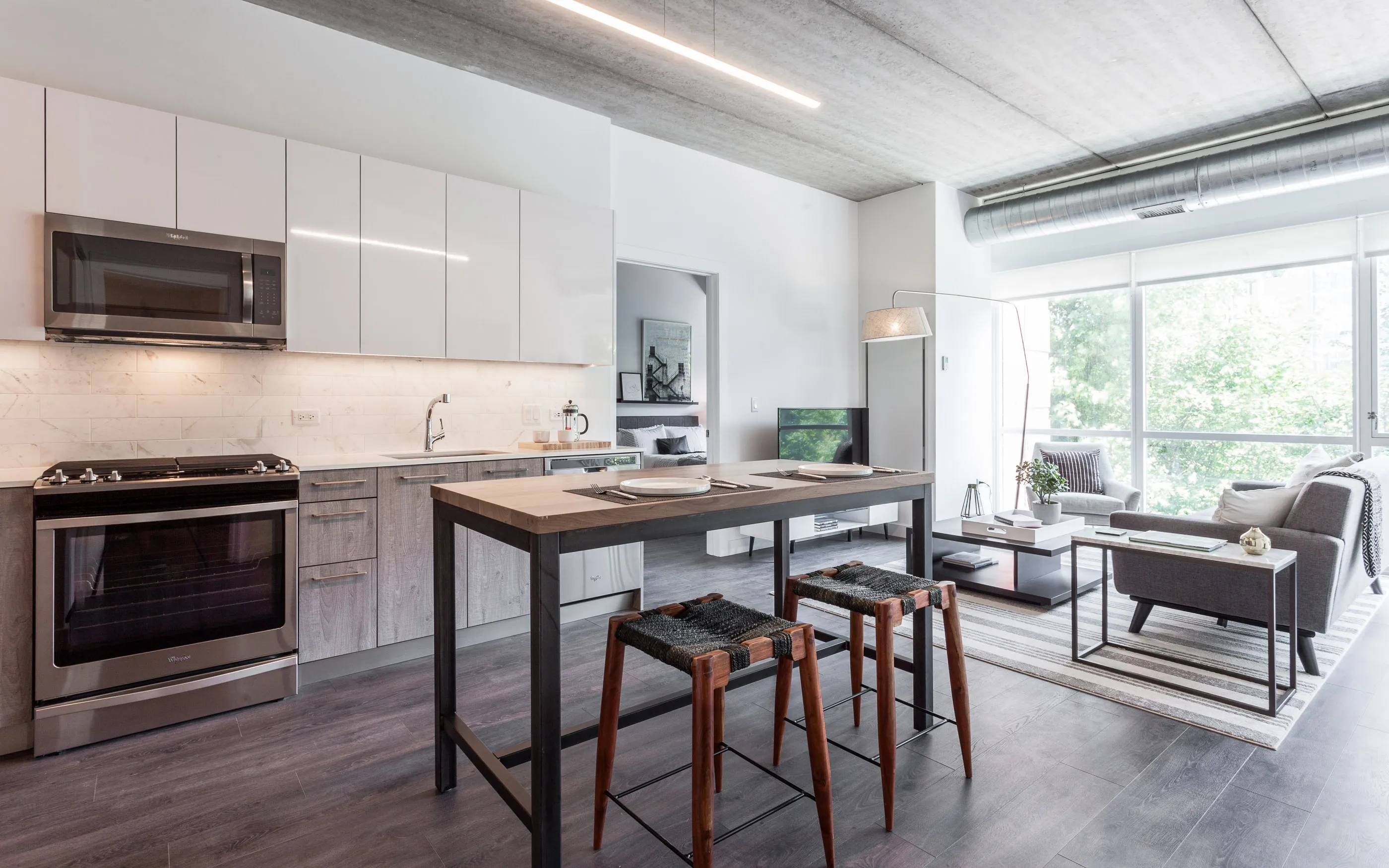 kitchen and living area in one bedroom model at Centrum Evanston Apartments