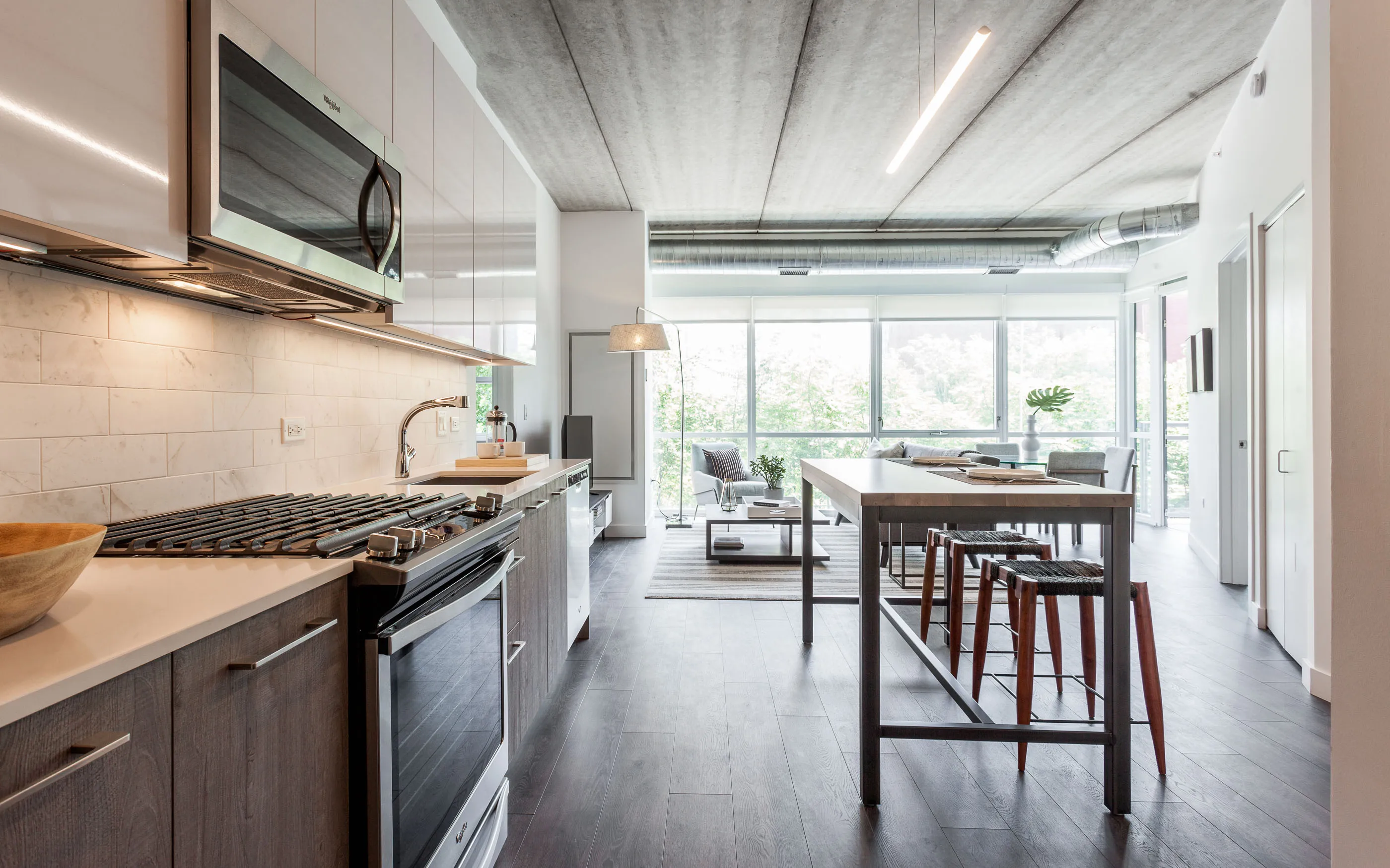 kitchen and living area in one bedroom model at Centrum Evanston Apartments