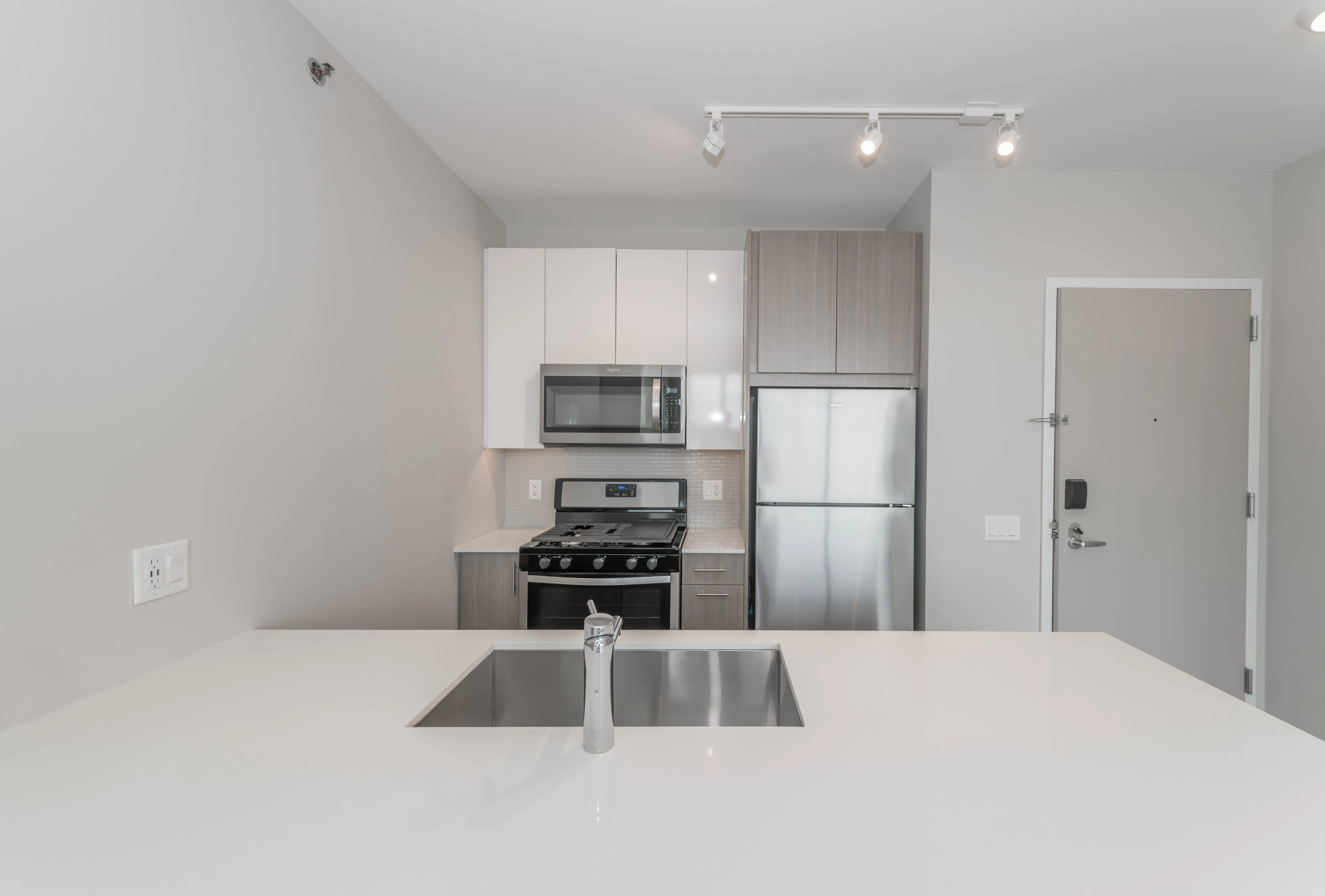 kitchen island, living area and view of the lake at Eleven40 Apartments