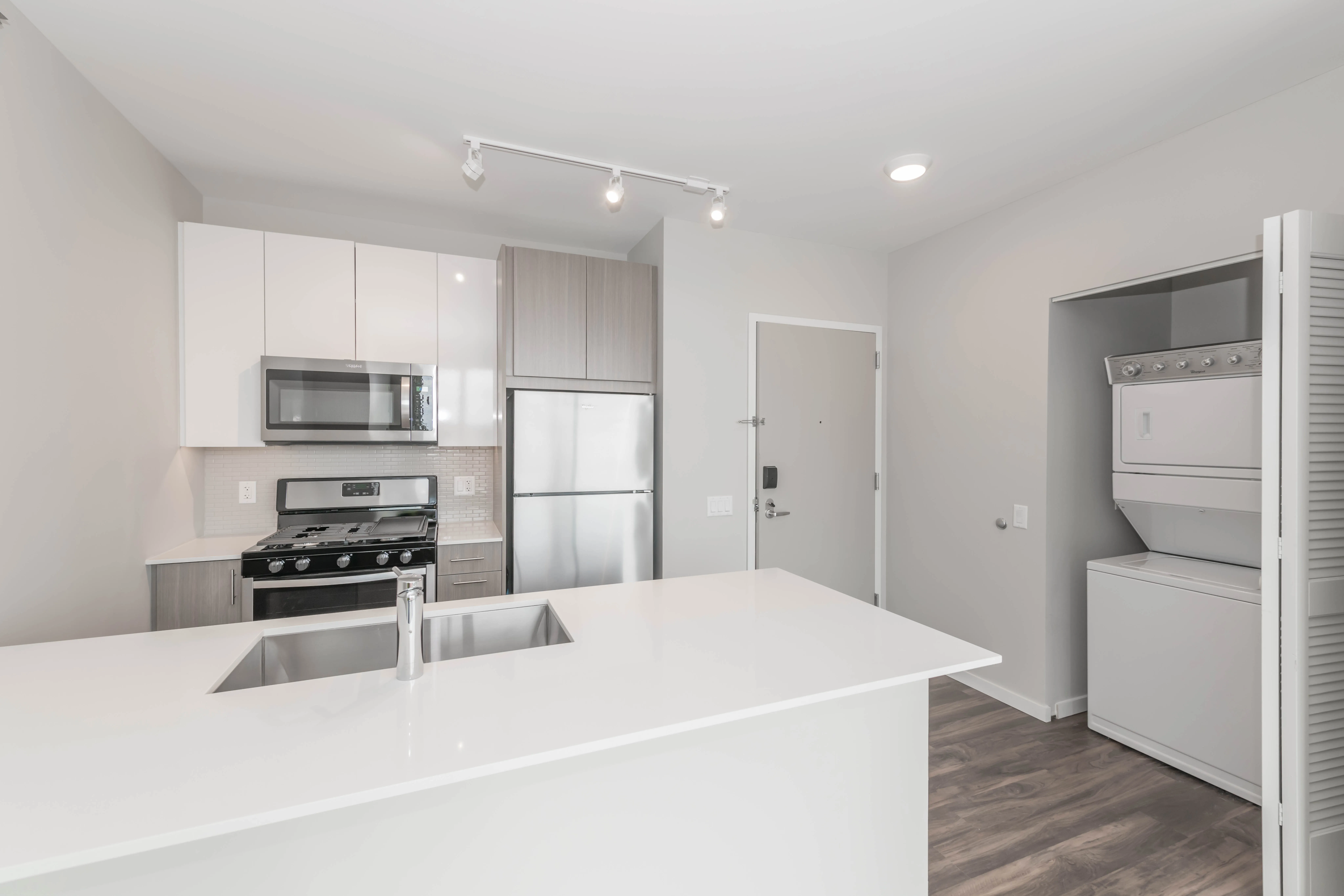 kitchen island, living area and view of the lake at Eleven40 Apartments