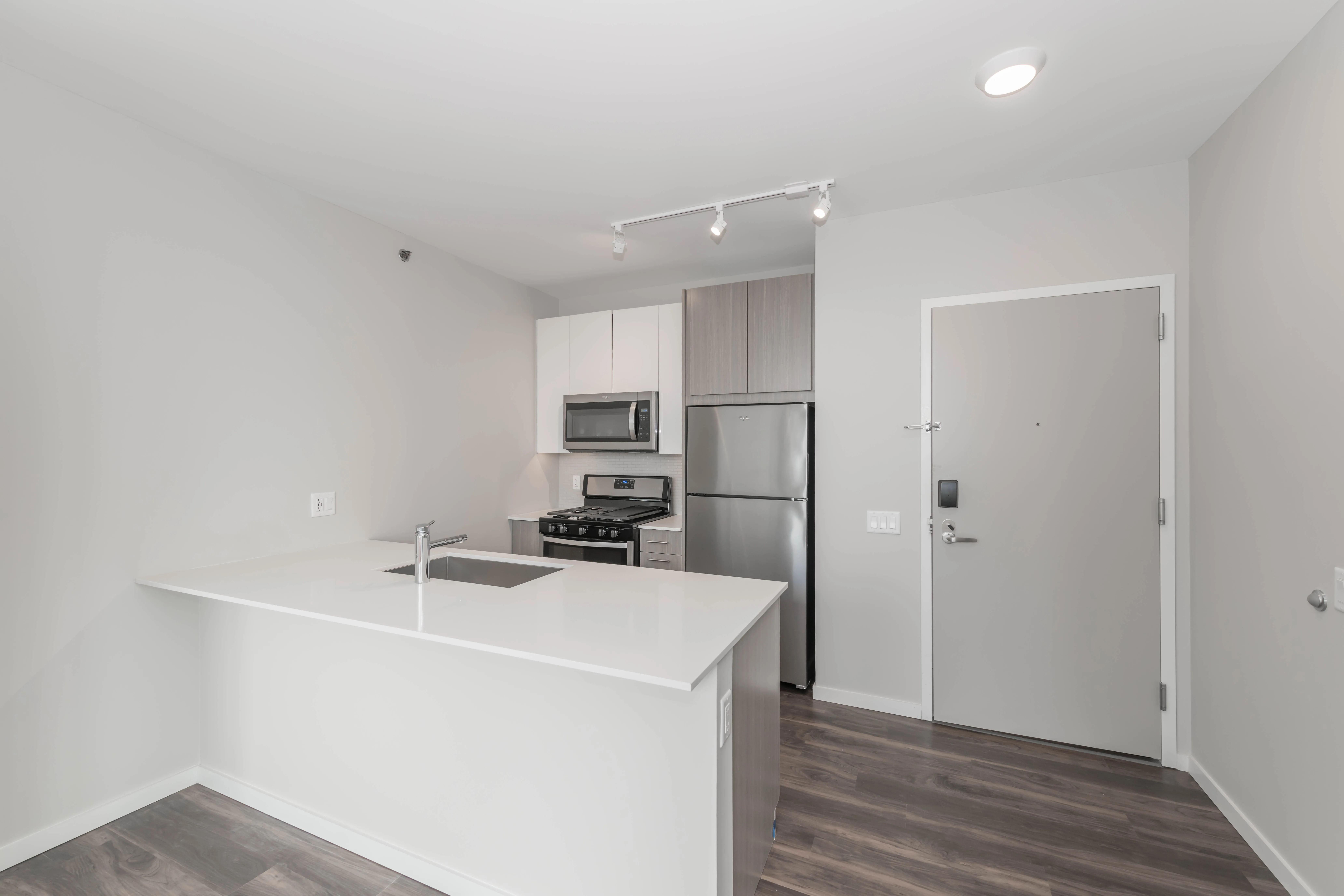 kitchen island, living area and view of the lake at Eleven40 Apartments