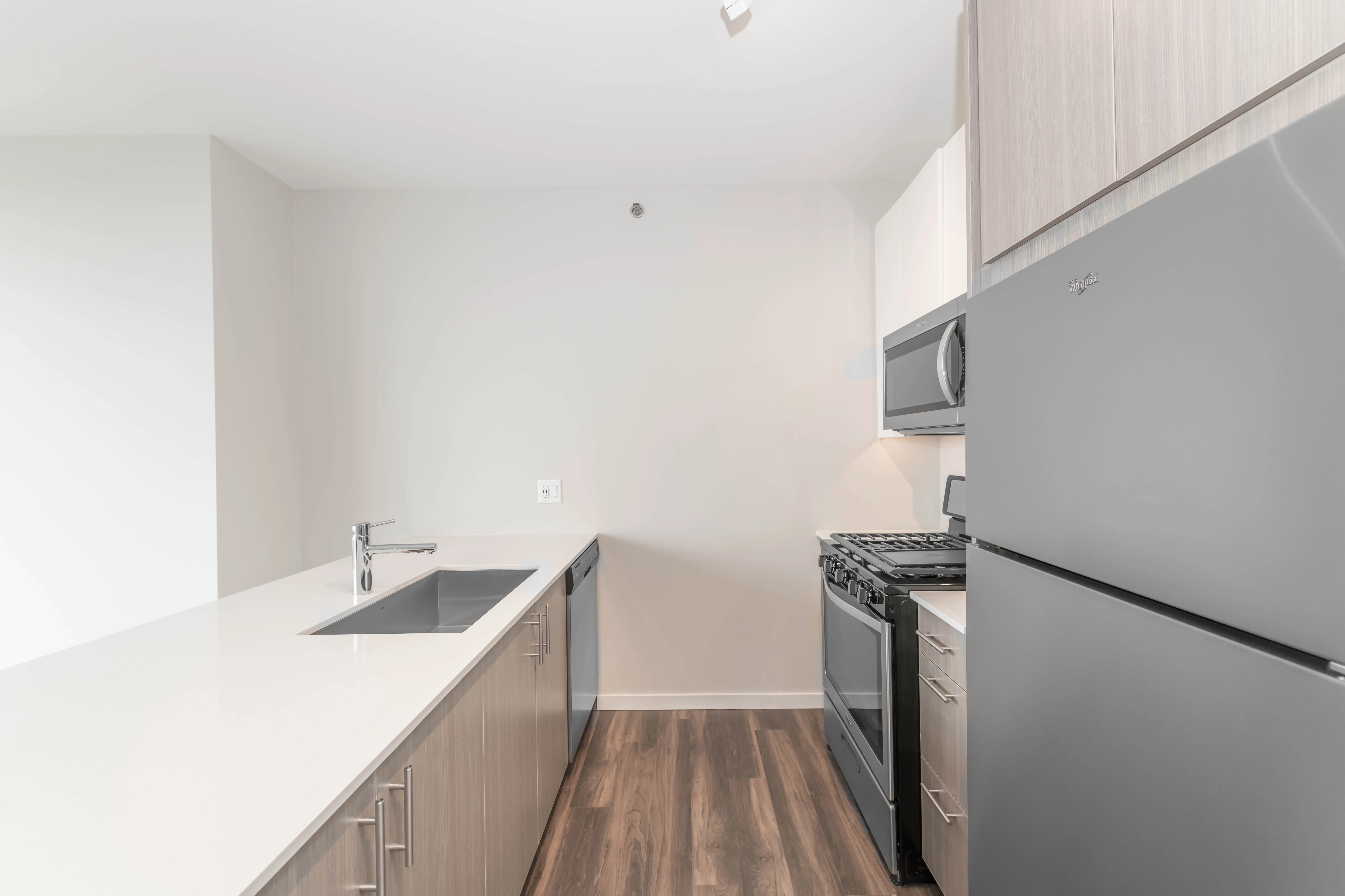 kitchen island, living area and view of the lake at Eleven40 Apartments