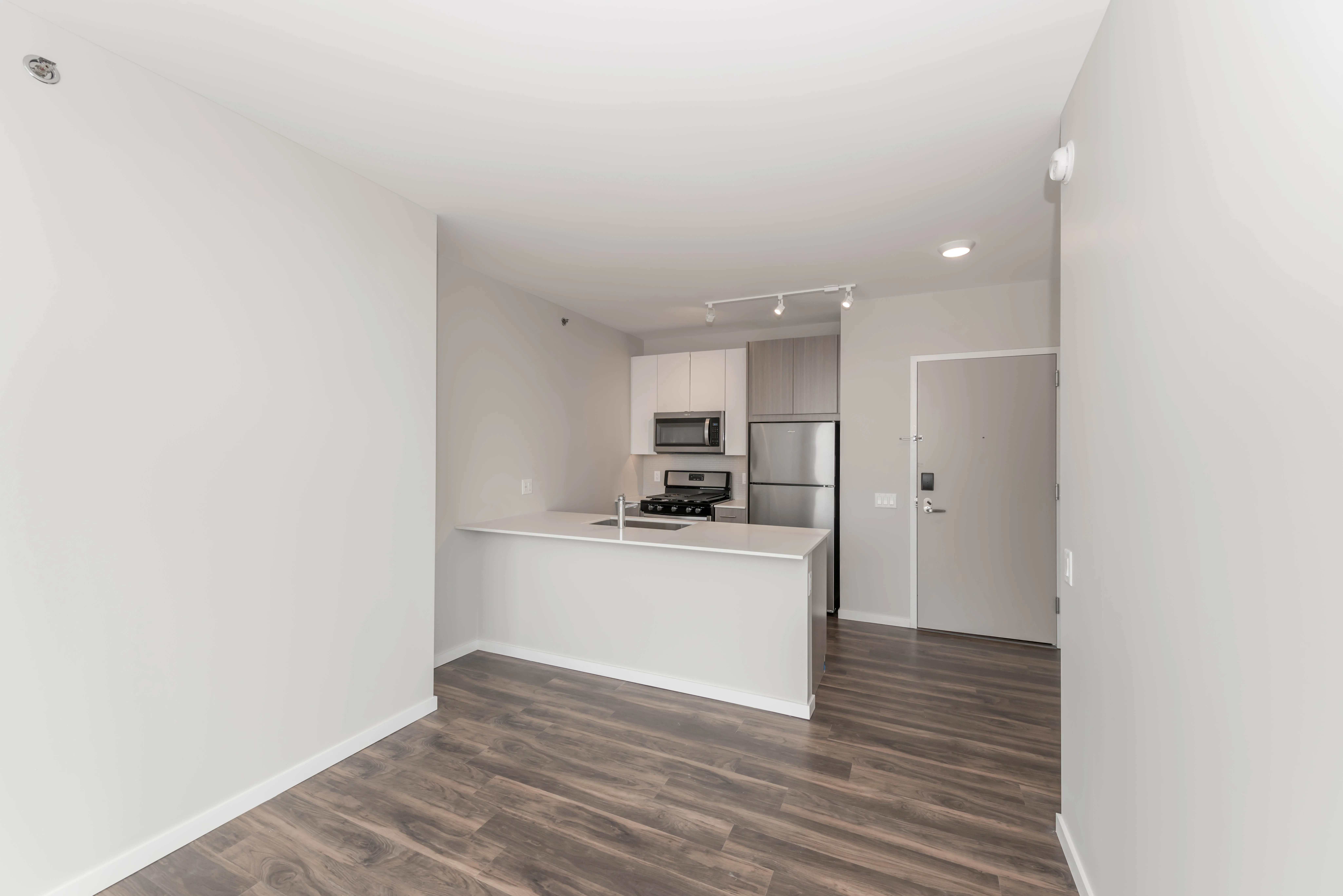 kitchen island, living area and view of the lake at Eleven40 Apartments