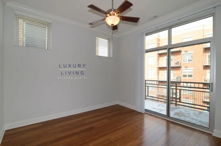 model kitchen and living room with wood floors at Huron Place Apartments