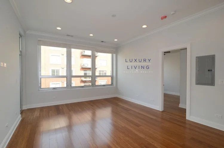 model kitchen and living room with wood floors at Huron Place Apartments