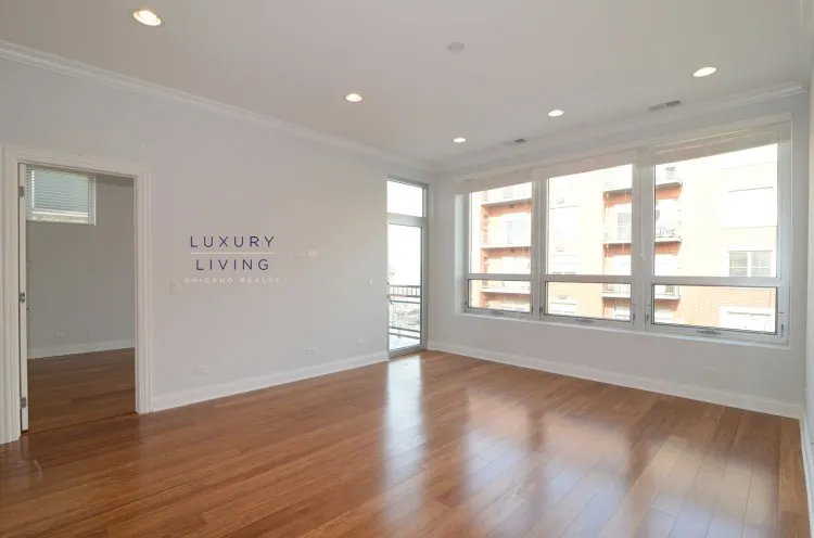 model kitchen and living room with wood floors at Huron Place Apartments