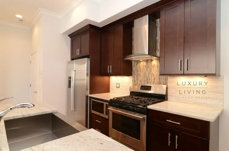 model kitchen and living room with wood floors at Huron Place Apartments