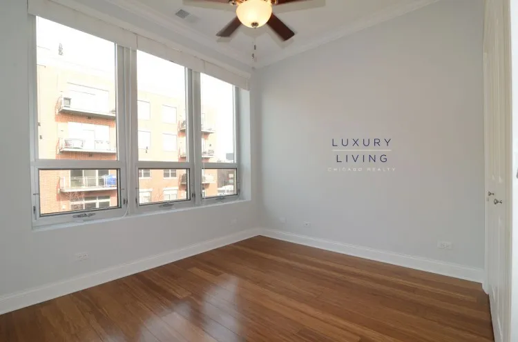 model kitchen and living room with wood floors at Huron Place Apartments