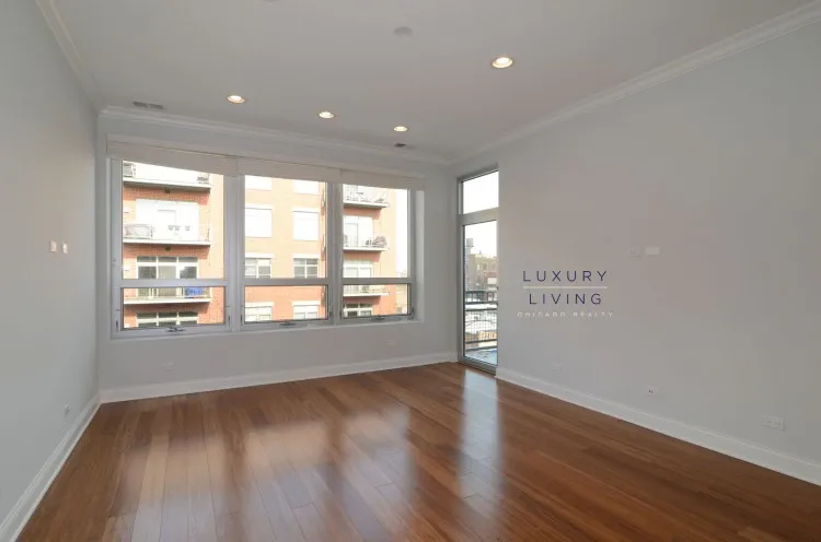 model kitchen and living room with wood floors at Huron Place Apartments