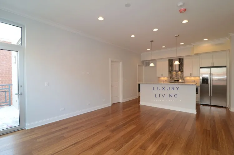 model kitchen and living room with wood floors at Huron Place Apartments