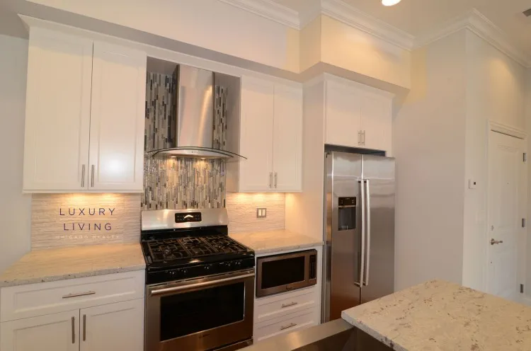 model kitchen and living room with wood floors at Huron Place Apartments