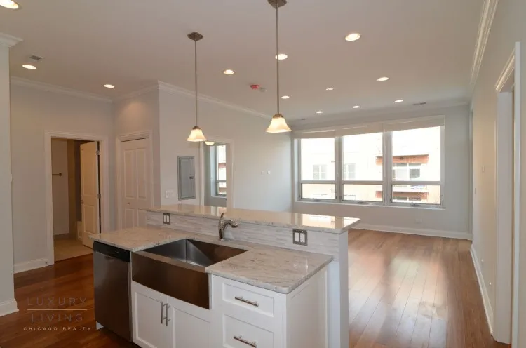 model kitchen and living room with wood floors at Huron Place Apartments