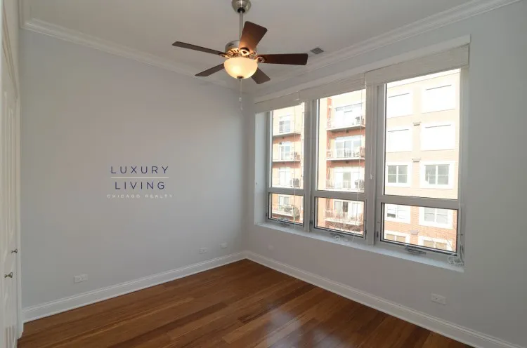 model kitchen and living room with wood floors at Huron Place Apartments