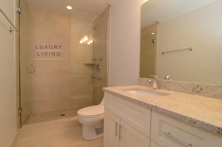 model kitchen and living room with wood floors at Huron Place Apartments