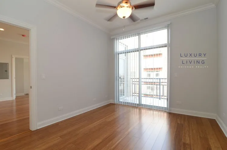model kitchen and living room with wood floors at Huron Place Apartments