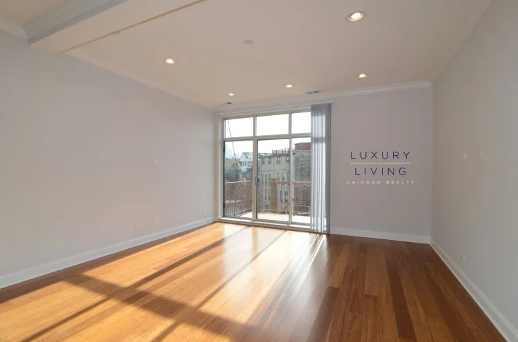 model kitchen and living room with wood floors at Huron Place Apartments