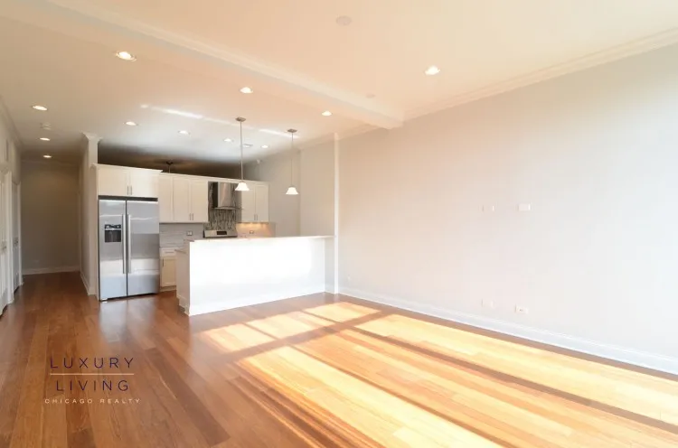 model kitchen and living room with wood floors at Huron Place Apartments